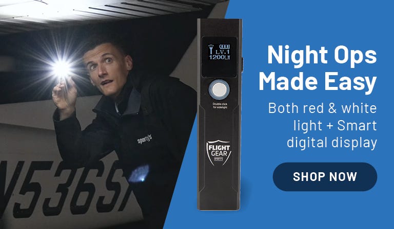 A pilot using the Flight Gear rechargeable Smart Flashlight, checking his airplane