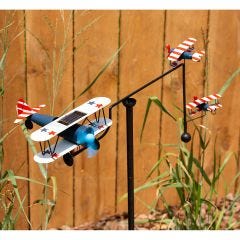 biplane balancer in front of fence 