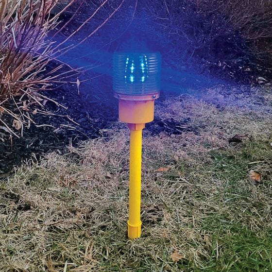 Blue Solar Powered Runway Light sticking in the ground Blue Solar Powered Runway Light sticking in the ground