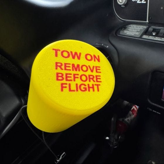 Tow On Remove Before Flight Cup up close 