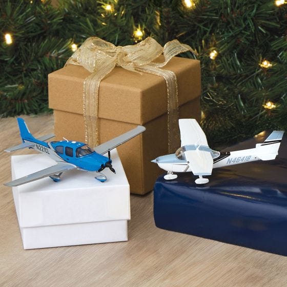 blue and grey cirrus and white and blue cessna models in Christmas scene