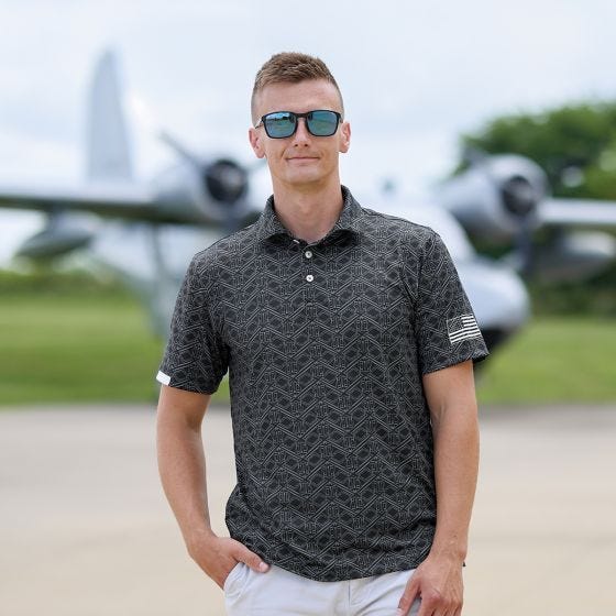 pilot wearing polo in front of an airplane 