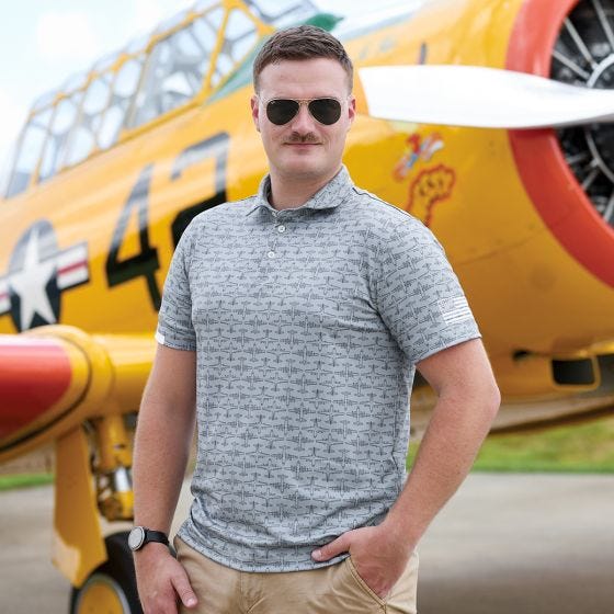 model wearing polo in front of airplane model wearing polo in front of airplane