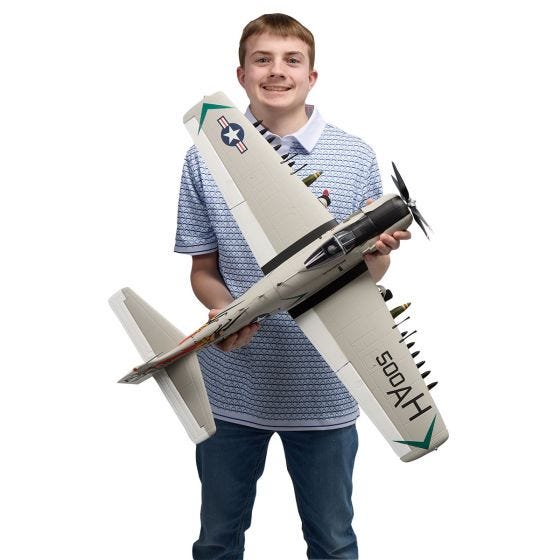 Someone holding the A-1 Sky Raider R/C Airplane