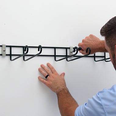 Person installing tool hanger easily