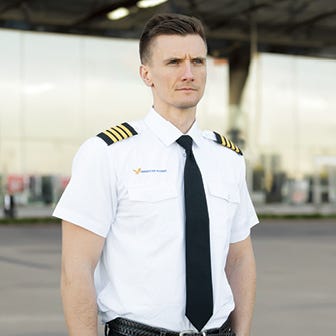 pilot standing wearing pilot shirt
