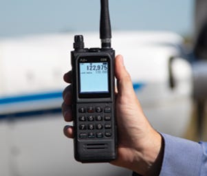 PJ2+ COM Radio being held for display in front of plane