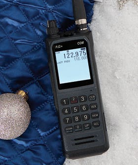 PJ2+ COM Radio displayed being help in the right hand