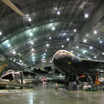 multiple military aircraft shown in hanger at museum