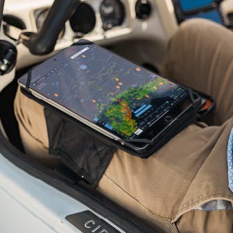 pilot wearing iPad kneeboard with iPad displaying aviation data