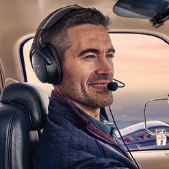 Pilot flying plane wearing aviation headset