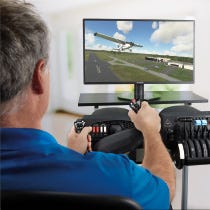 person using flight simulator equipment at desktop computer