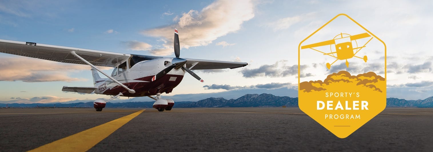 Cessna plane on runway with mountains in background