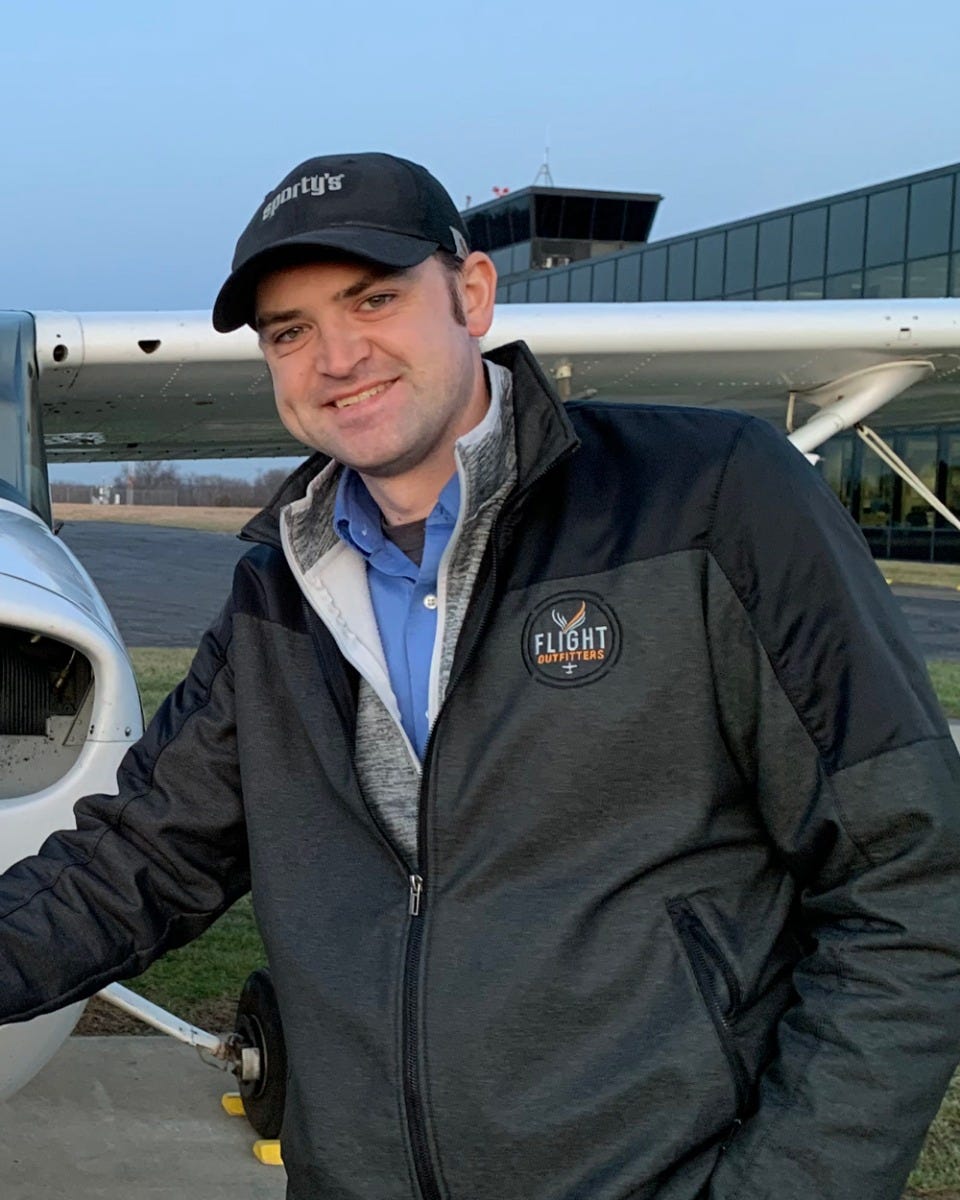 Dustin Yockey standing in front of a plane