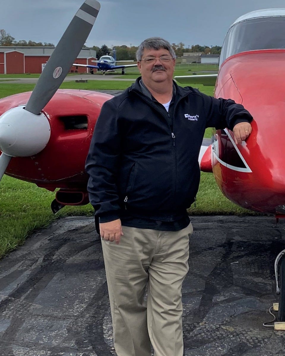 Eric Carnahan standing in front of plane