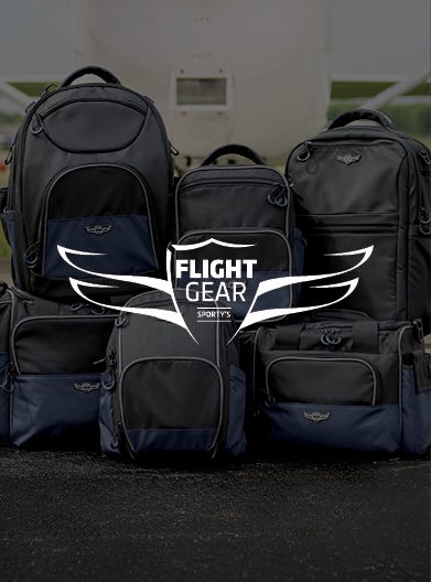 flight gear with flight gear bags displayed in background with logo on top
