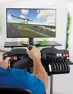 Desktop flight simulator setup with user flying plane