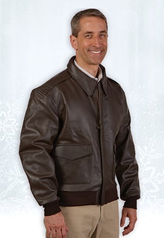 Pilot standing in front of plane wearing aviation leather jacket