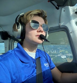 Jayme Frederick standing next to a plane