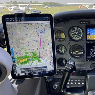 iPad shown mounted next to yoke inside of plane
