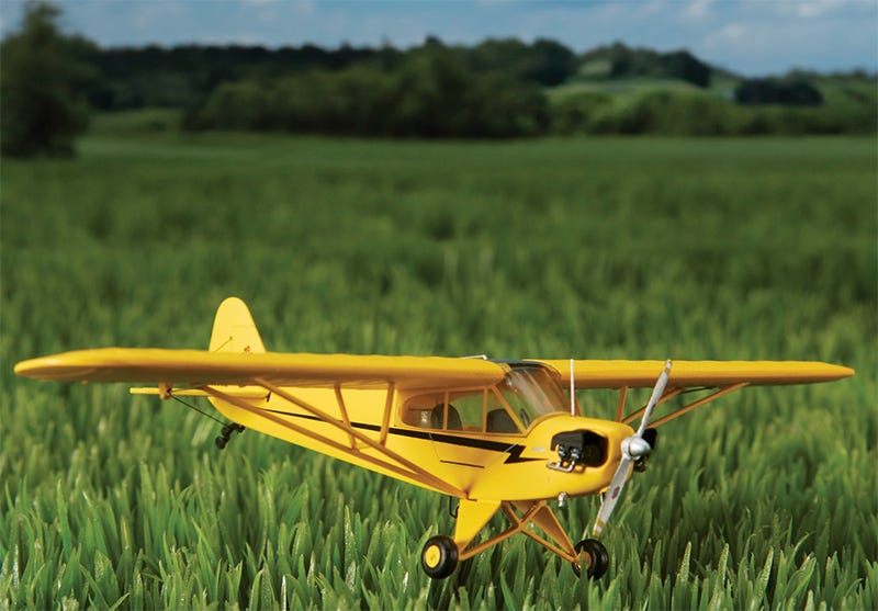 Yellow J3 Cub Model on green grass