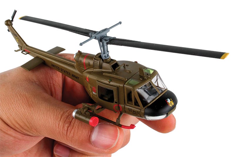 Green UH-1C US Army Huey Gunship model on stand