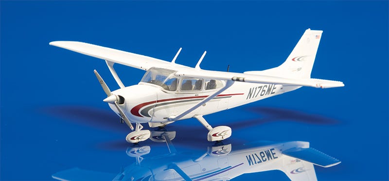 White and Maroon Cessna 172 model on blue background