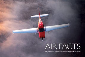 red plane flying over layer of clouds