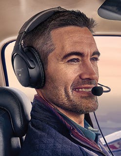 pilot wearing bose headset in cockpit