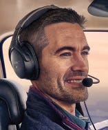 pilot wearing bose headset in cockpit