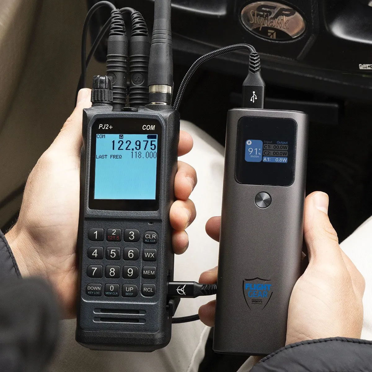 PJ2+ COM Radio displayed with it being plugged into backup battery