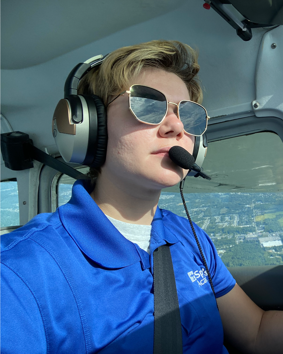 Jayme Frederick standing next to a plane