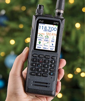 PJ2+ COM Radio displayed being help in the right hand