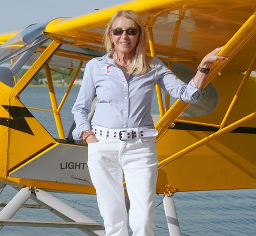 Patty Wagstaff standing in front of a seaplane.