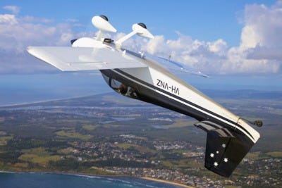 A small airplane in a steep downward nose-dive toward the earth below