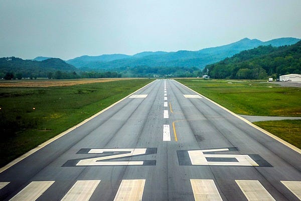 View from the cockpit of an airplane on short final approach to a runway